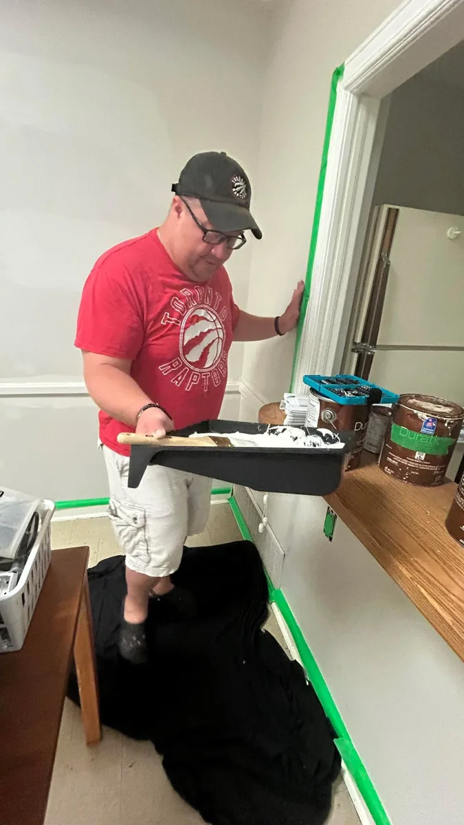 A lodge volunteer painting during improvements to the hall